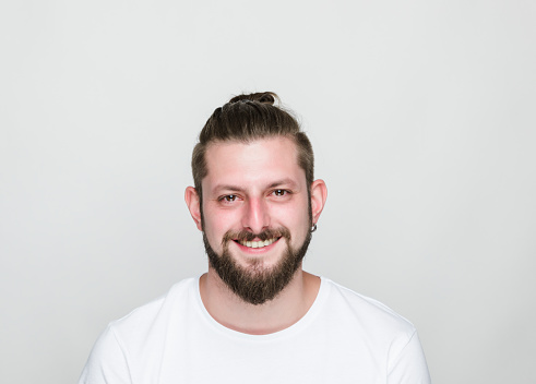 Smiling young man on white  background, studio shot