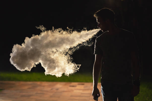 istock The man smoking on the street. evening night time 1060211588