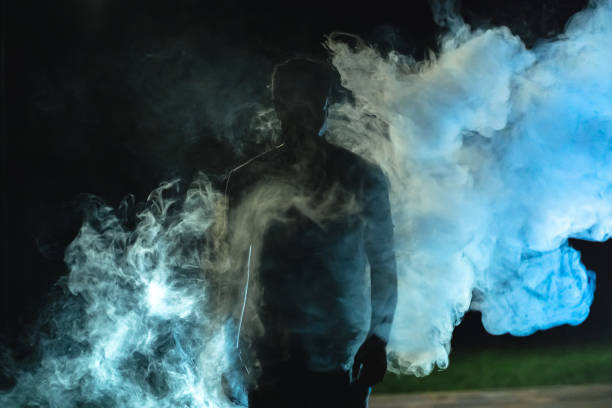 istock The man standing in the smoke on the dark background 1060211594