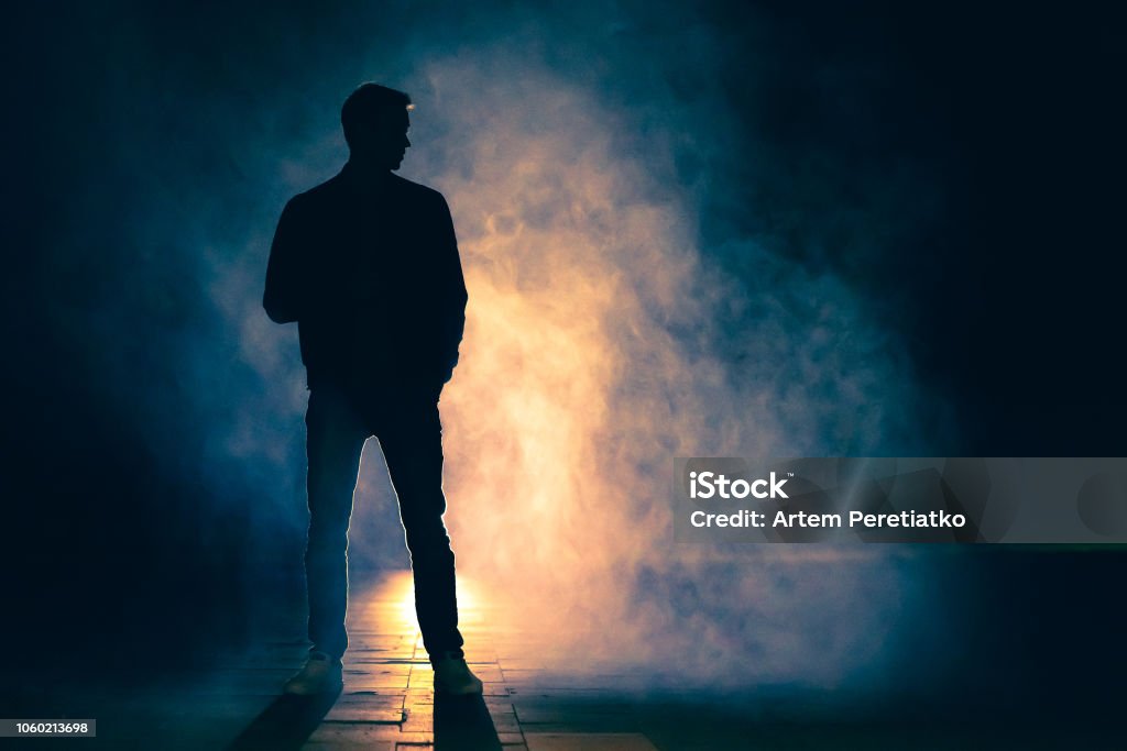 The man standing in the fog. evening night time Men Stock Photo