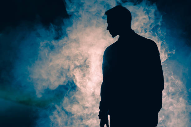 istock The man silhouette standing in the smoke. evening night time 1060213718