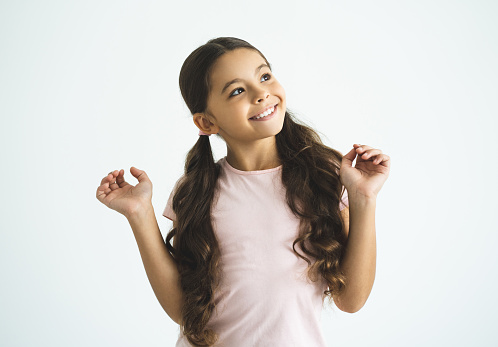 The happy girl gesturing on the white background