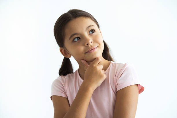 The thoughtful girl standing on the white background stock photo