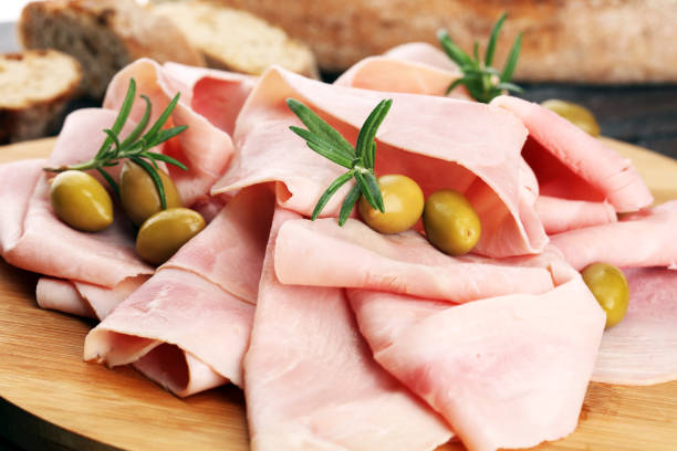 istock Sliced ham on wooden background. Fresh prosciutto. Pork ham sliced. 1060219330