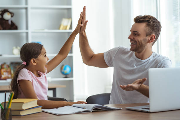 The father and a daughter sitting at the table and gesturing