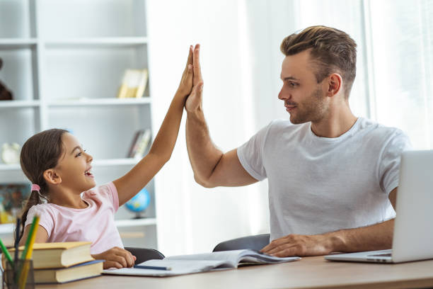 istock The father and a daughter sitting at the table and gesturing 1060219524