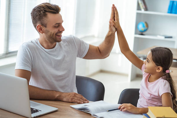 istock The father and a daughter sitting at the table and gesturing 1060219542