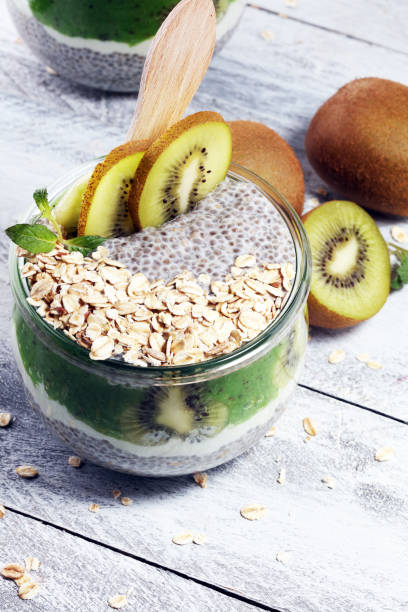 istock Healthy breakfast. chia pudding with kiwi and granola in glass on rustic background. 1060219980