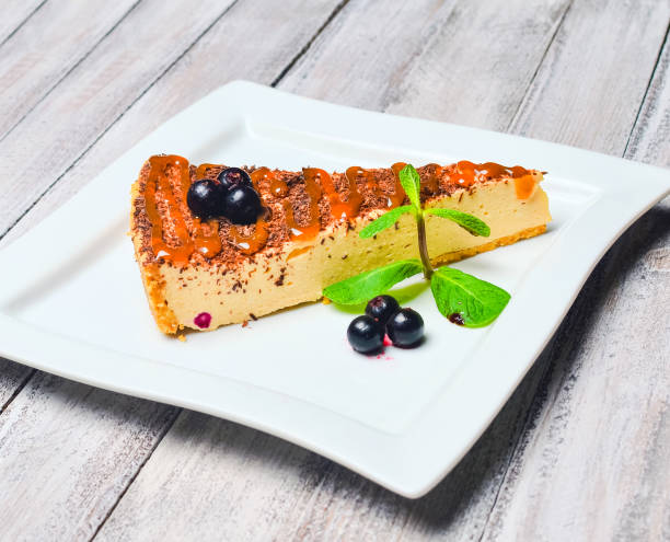istock Cheesecake with chocolate on a wooden table. 1060220172