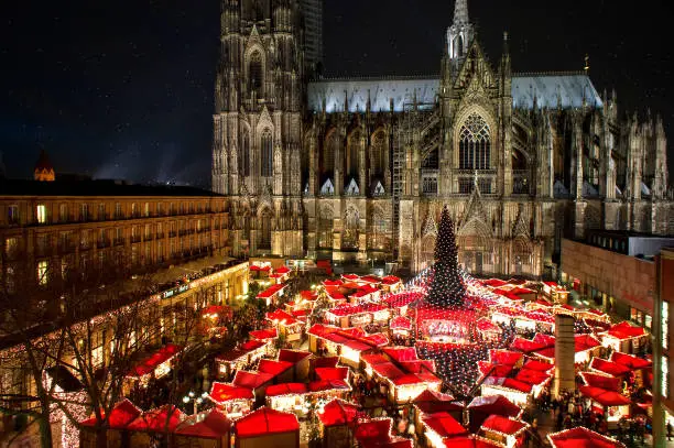 Panorama view of cologne cathedral christmas market with world heritage site cologne cathedral at night.