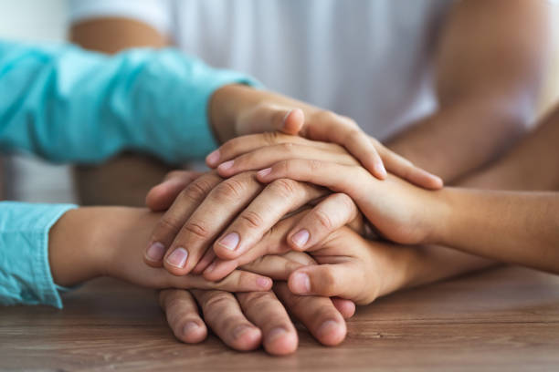 istock The family hold hands together at the table 1060222380