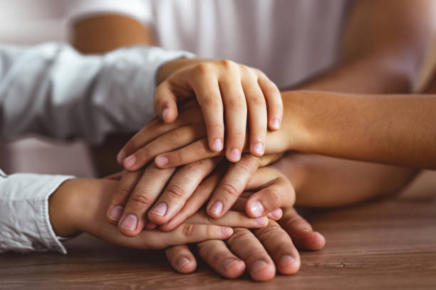 istock The three people hold hands together at the table 1060222386