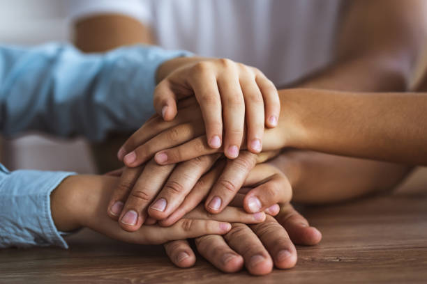 istock The three people hold hands together at the table 1060222388