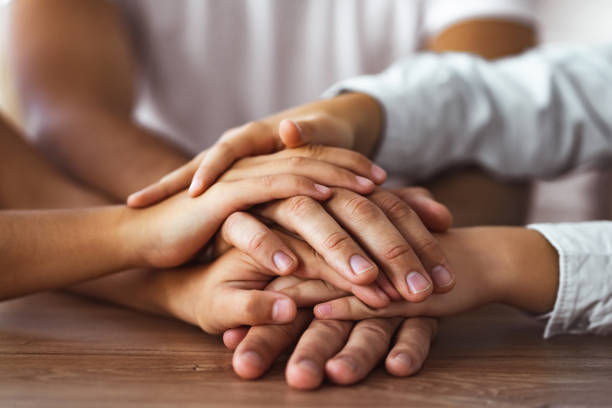 istock The family hold hands together at the table 1060222392
