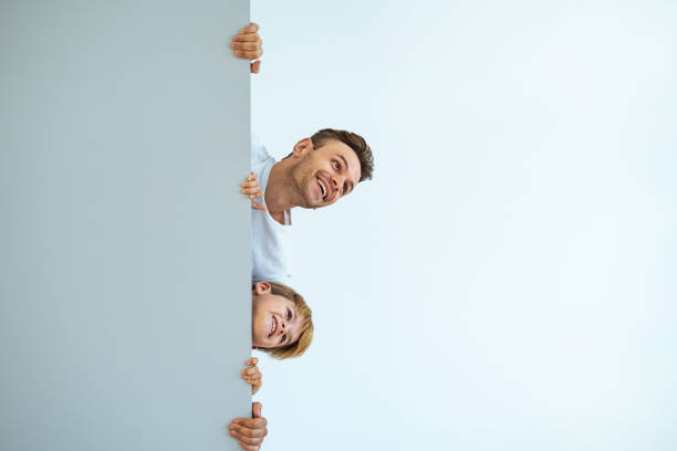 istock The happy father and a son stand behind the wall 1060222456