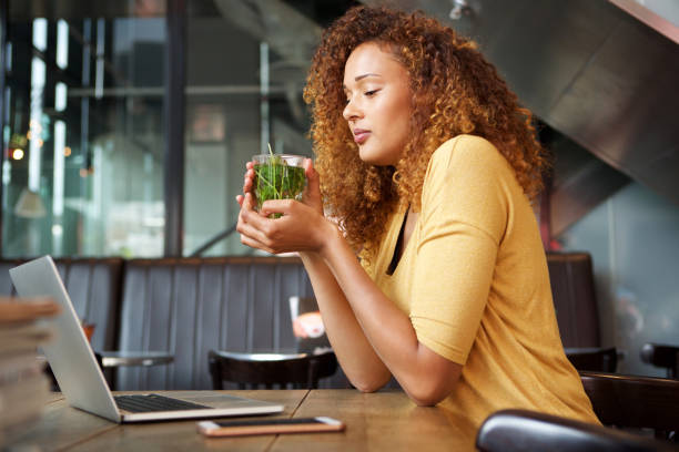 istock attractive young woman sitting at cafe drinking tea 1060224668