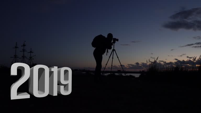 Silhouette of a young man like to travel and photography Photos