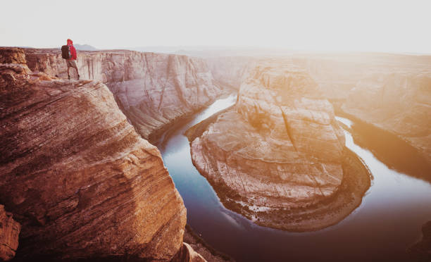 istock Hiker overlooking Horseshoe Bend at sunset, Arizona, USA 1060240338