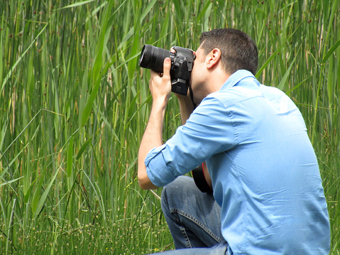 Bolu, Turkey - May 26, 2018: A blue shirt man photographs abant lake in bolu - turkey. He travels and discovers nature. Abant Lake which is at 1350 m high from ground in Bolu Turkey.