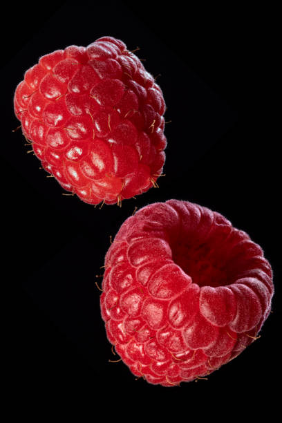 Fresh organic ripe raspberries on a black background. An isolated object.