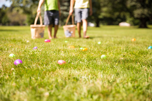 easter eggs hunt. blurred silhouettes of children with baskets in hands. - easter egg easter grass spring imagens e fotografias de stock