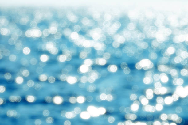 Abstract background image of defocused lights of shiny sea surface in sunny day