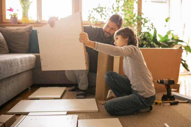 istock Father and son assembling bookshelves at their home 1060254978