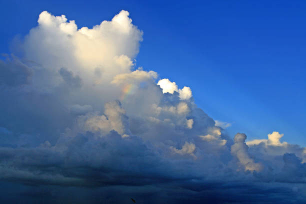 Brilliant blue clear sky with white and dark clouds storm moving in