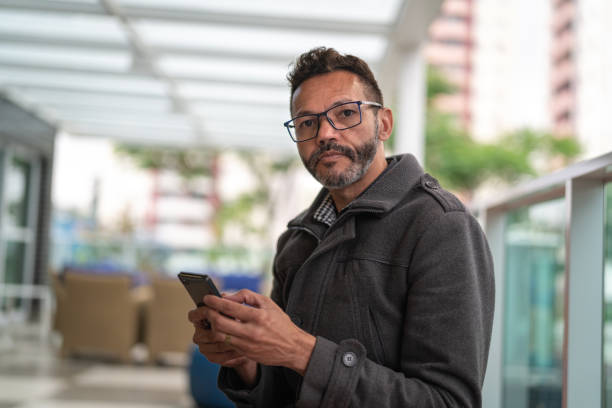 istock Mature Man Using Mobile at Home Office - Portrait 1060275730