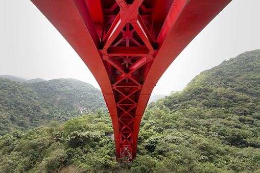 A mega structure red bright connects to the other side of the mountain.