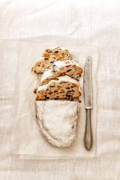istock Traditional German Christmas fruit cake shtalen on bright linen tablecloth. View from above,flat lay, copy space 1060281016