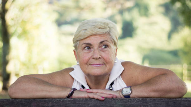 beautiful older lady portrait outdoors - idealist imagens e fotografias de stock