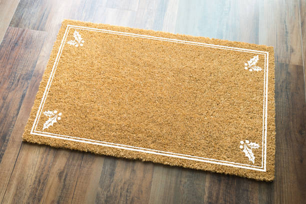 istock Blank Holiday Welcome Mat With Holly On Wood Floor Background 1060295964