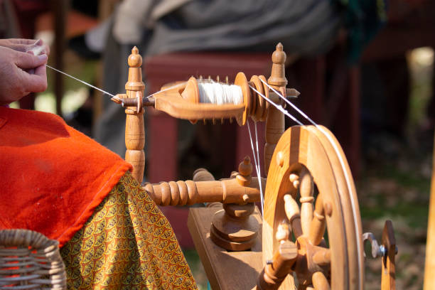 istock Female artisan spins yarn with spinning wheel 1060313268