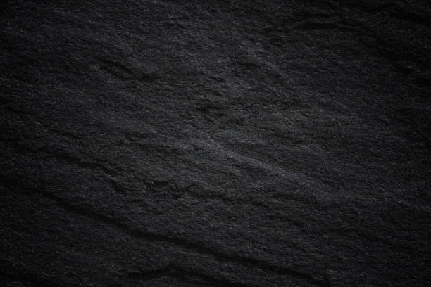 istock Dark grey black slate background or natural stone texture. 1060337162