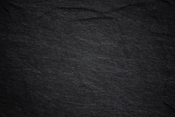 istock Dark grey black slate background or natural stone texture. 1060337194