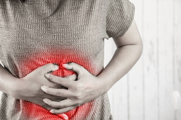 istock woman hand touching her stomach pain 1060339976