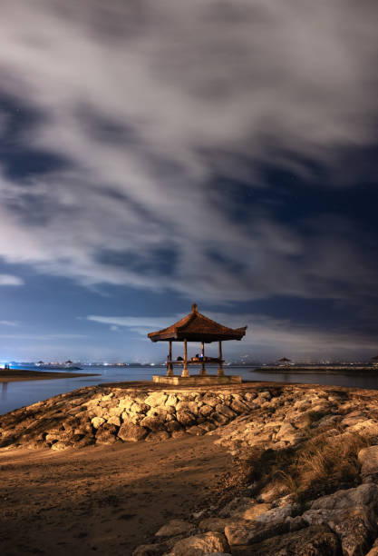 istock Pavilion on rock jetty with cloudy in sanur beach 1060344980