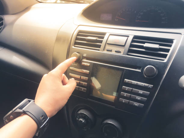 istock classic interior and display control in old car with old panel control, hand press the radio button inside a car, technology and transportation concept 1060356378