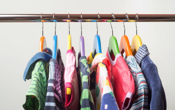 istock Hangers with colourful clothes isolated on white background 1060357598