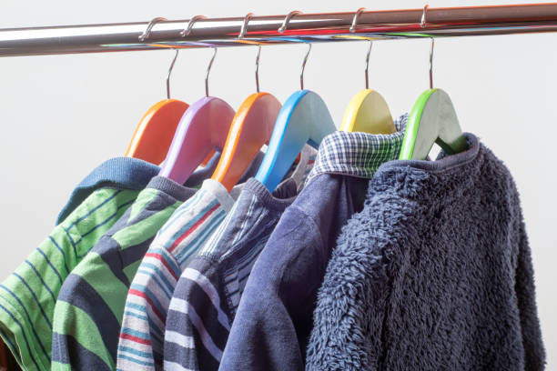 istock Hangers with colourful clothes isolated on white background 1060358646