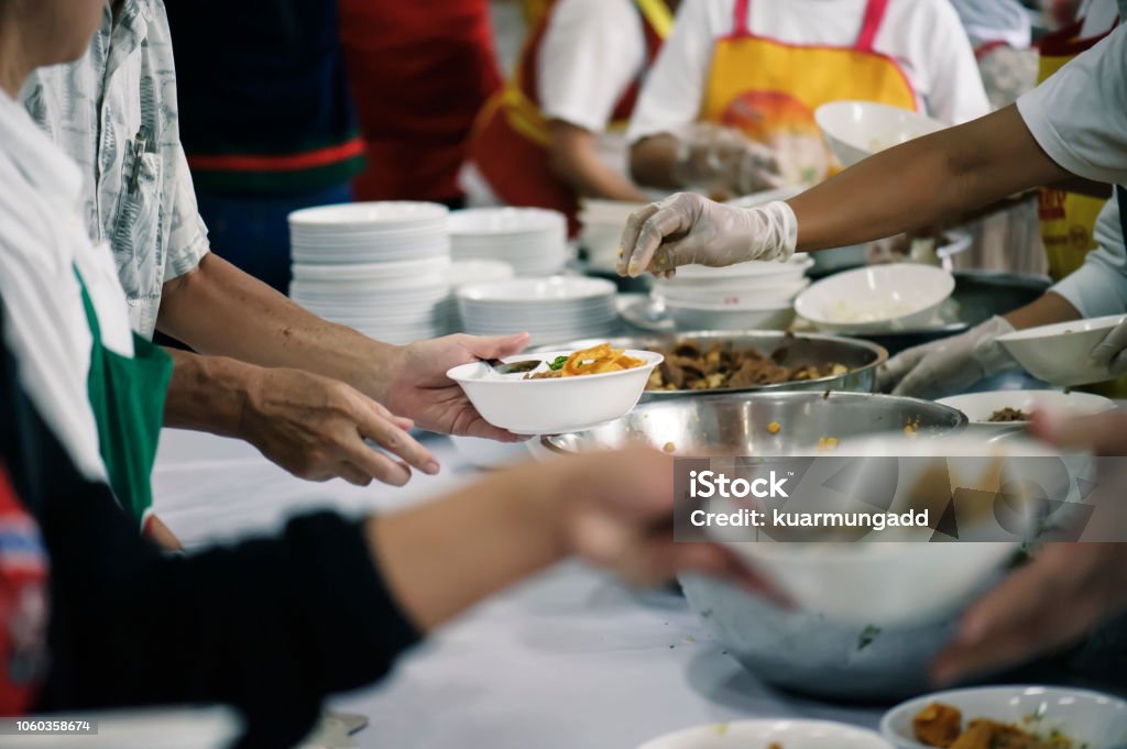 Volunteers Share Food to the Poor to Relieve Hunger: Charity concept Homelessness Stock Photo