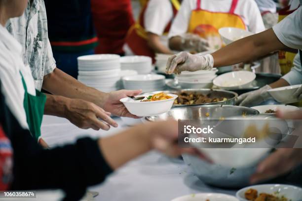 Volunteers Share Food To The Poor To Relieve Hunger Charity Concept Stock Photo - Download Image Now