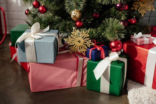 istock colorful presents under christmas tree with baubles in room 1060360108