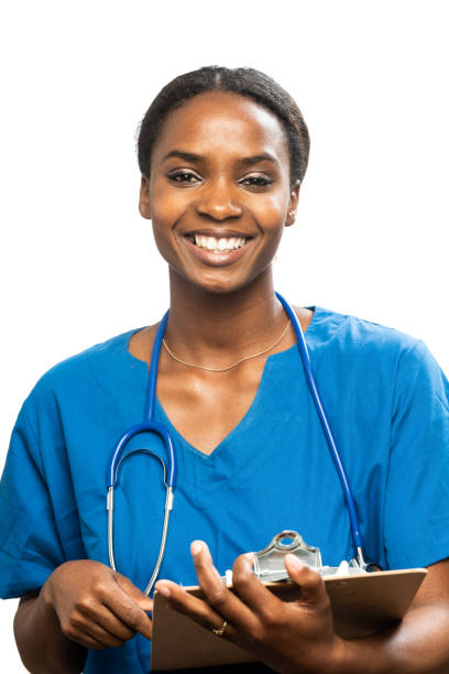Young black female health care worker Young black female health care worker looking at the camera writing in a clipboard kenyan culture stock pictures, royalty-free photos & images