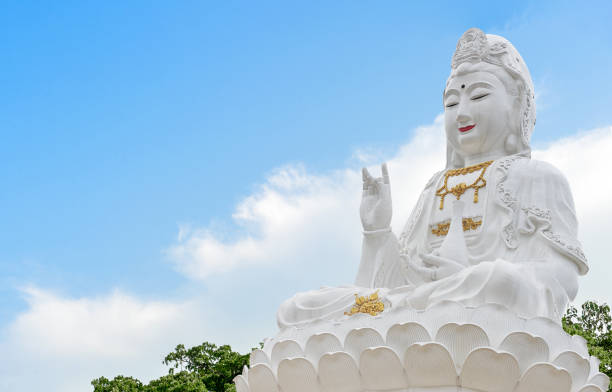 istock Kuan Yin buddha on sky with soft-focus and over light in the background 1060380606