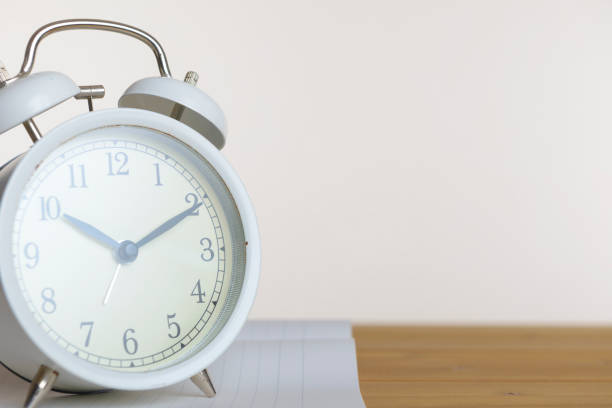 istock Alarm Clock and Wood Board 1060380758