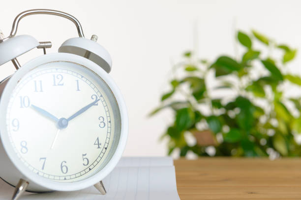 istock Alarm Clock and Wood Board 1060380782