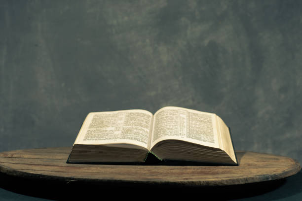 istock Bible on a round old wood table. Beautiful dark background. Religious concept. 1060383770