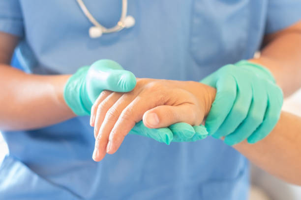 surgeon, surgical doctor, anesthetist or anesthesiologist holding patient's hand for health care trust and support in professional er surgical operation, medical anesthetic safety, healthcare concept - trust imagens e fotografias de stock